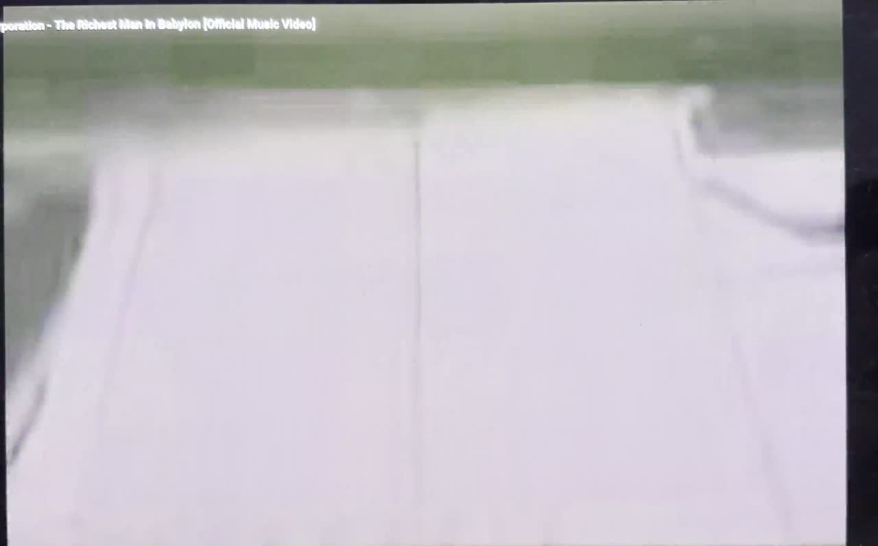 Video beside a neon-green volume ball on a dotted background